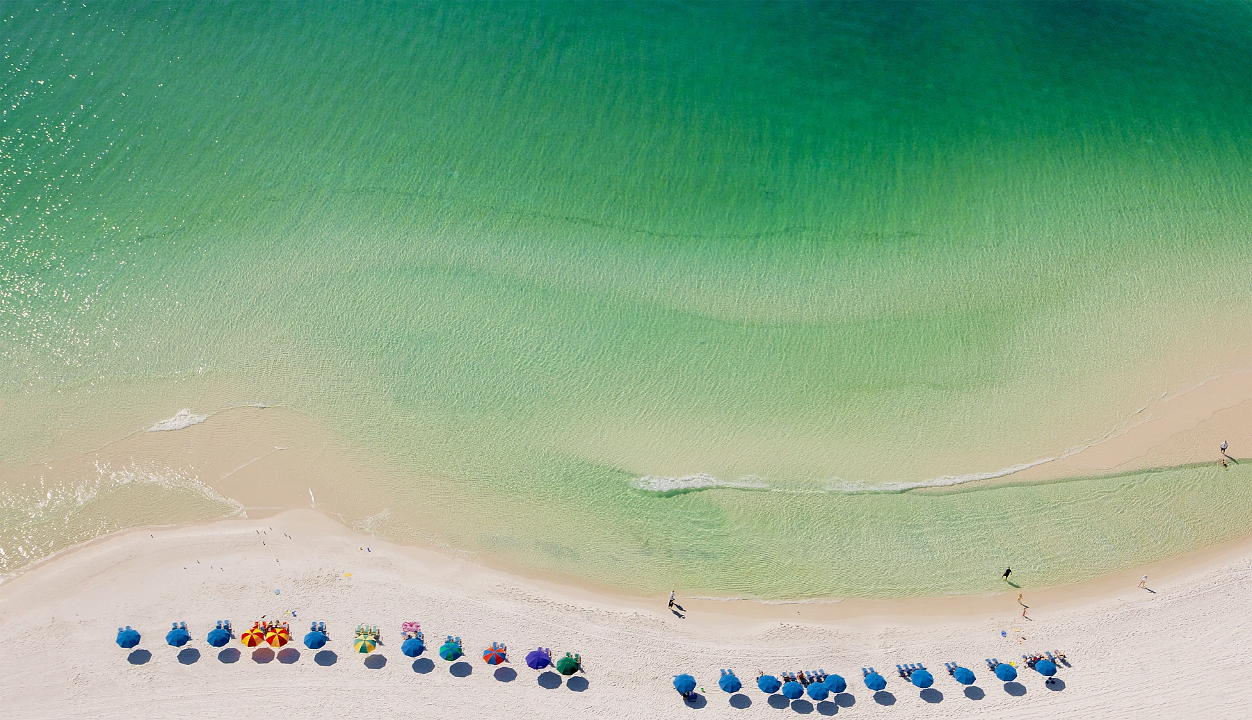 White sand and emerald green water on the Emerald Coast.